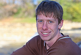 A teenage boy looking into the camera and smiling 